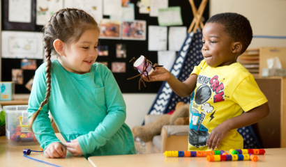 A preschool-aged boy and girl interact.