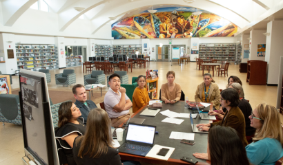 School leaders gather around a table.