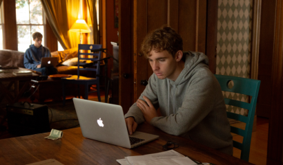 Students stare at their computer screens as they work from home.